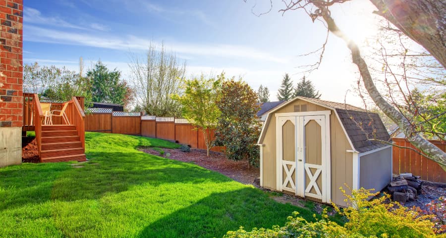 Fenced backyard with storage shed in Appleton